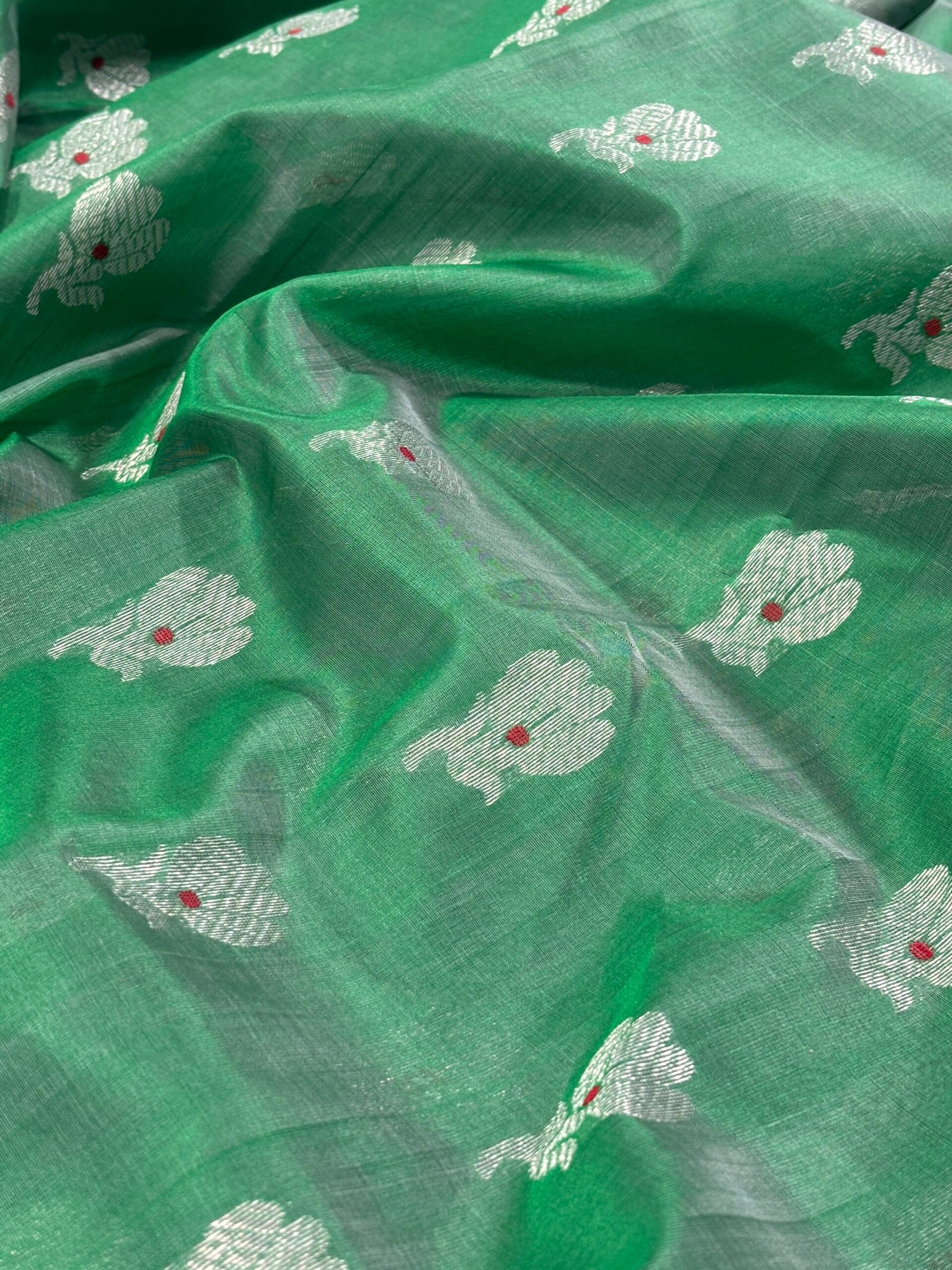 Original Chanderi Saree in Green with Silver Zari Buti | ChanderiThread Original Chanderi saree in bottle green with silver zari buti motifs and elegant silver border displayed on a flat surface.